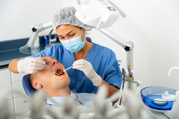Dentist performing gum disease treatment for a patient in Lowell, MA